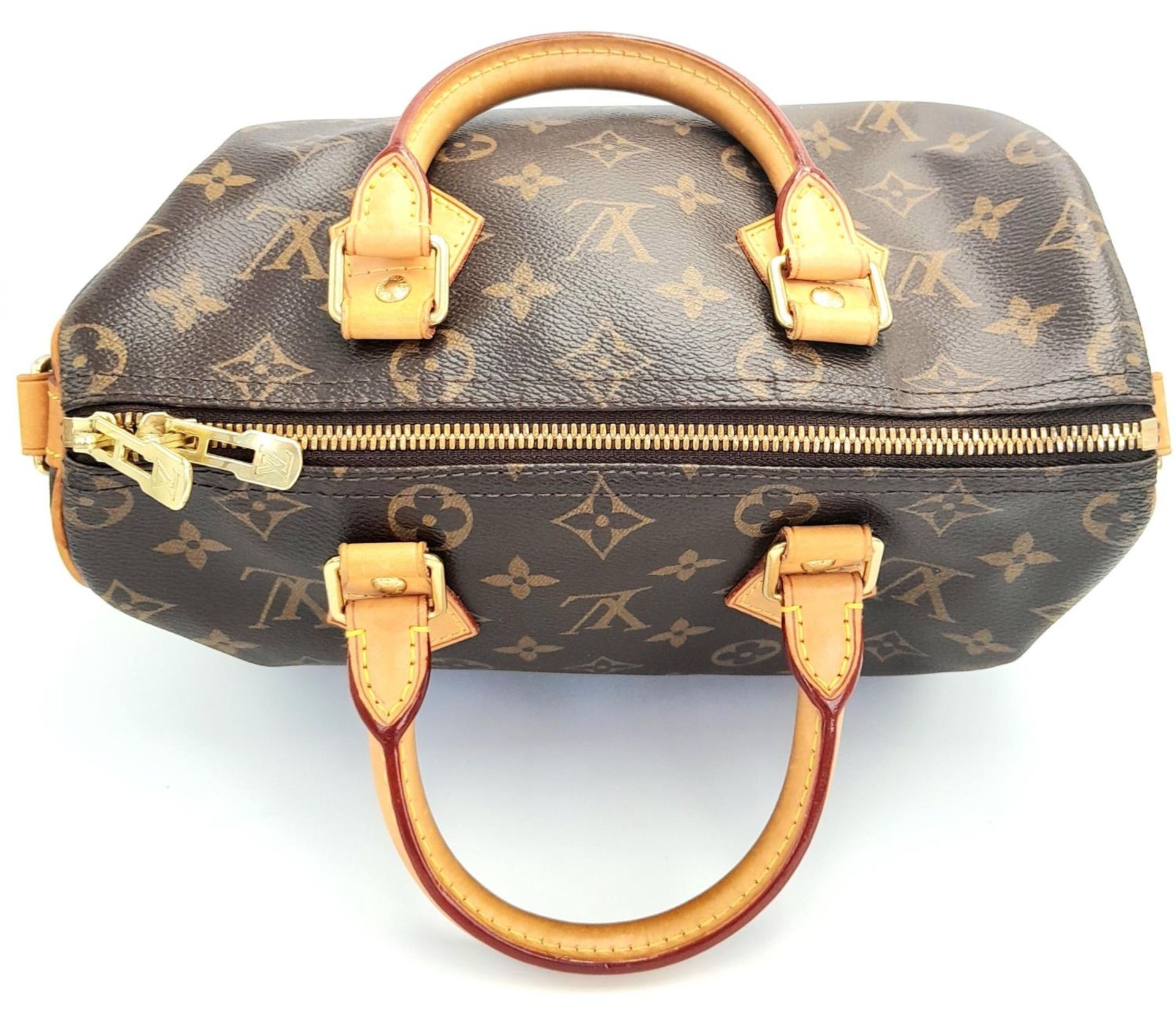 A Louis Vuitton Speedy Bag. Monogramed canvas exterior with gold-toned hardware, two rolled - Bild 5 aus 12