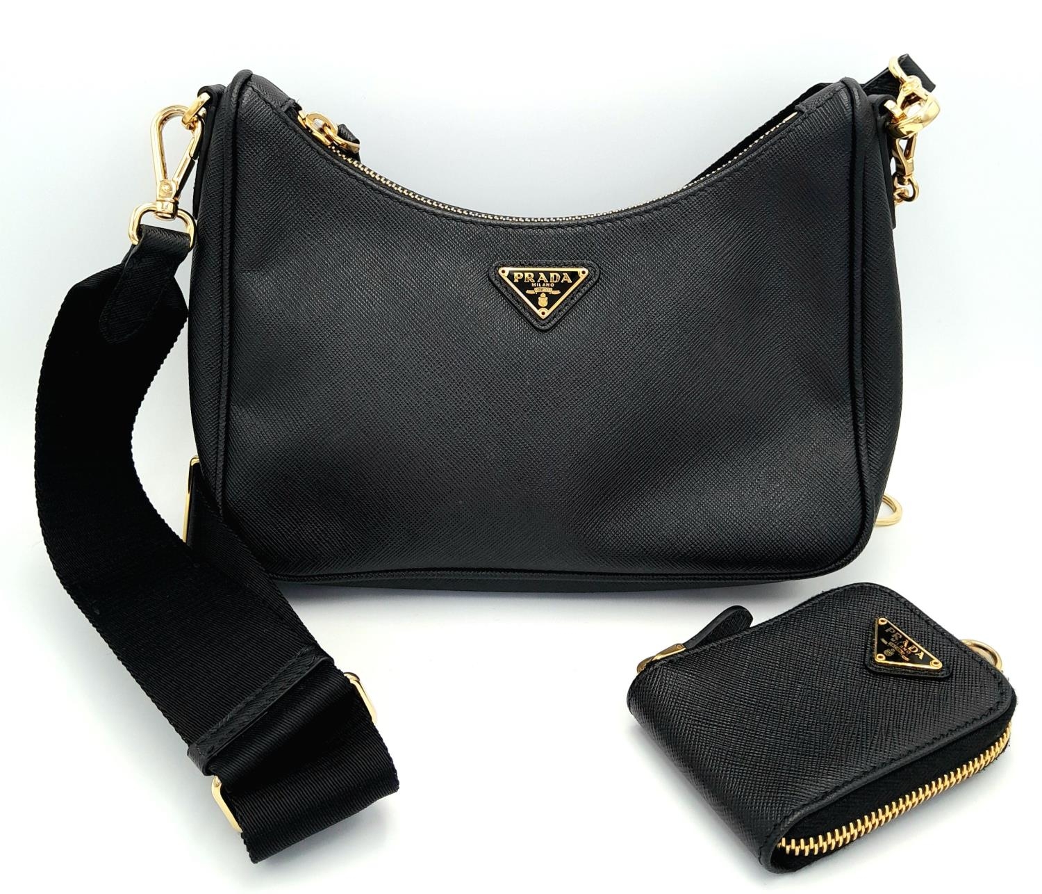 A Prada Black Re-Edition 2005 Bag. Saffiano leather exterior with gold-toned hardware, zip top