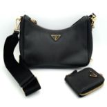 A Prada Black Re-Edition 2005 Bag. Saffiano leather exterior with gold-toned hardware, zip top