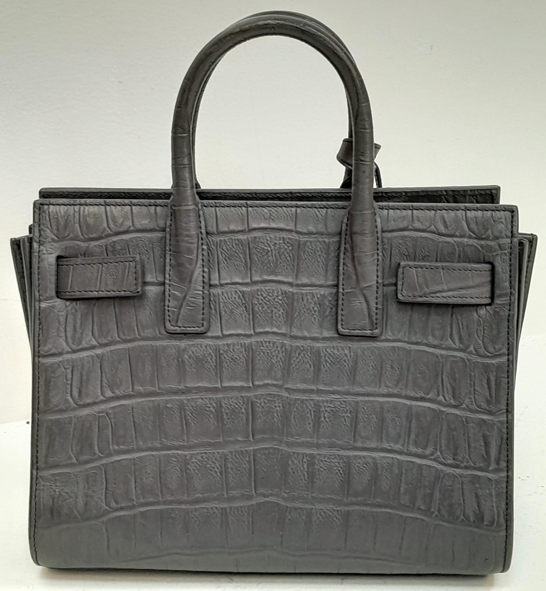 A Saint Laurent Grey Crocodile Embossed Small Sac De Jour Bag. Gold tone padlock (no key). Soft - Image 2 of 6