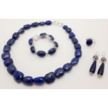 A Lapis Lazuli Jewellery Suite. Includes: necklace, earrings, bracelet and ring - size S.