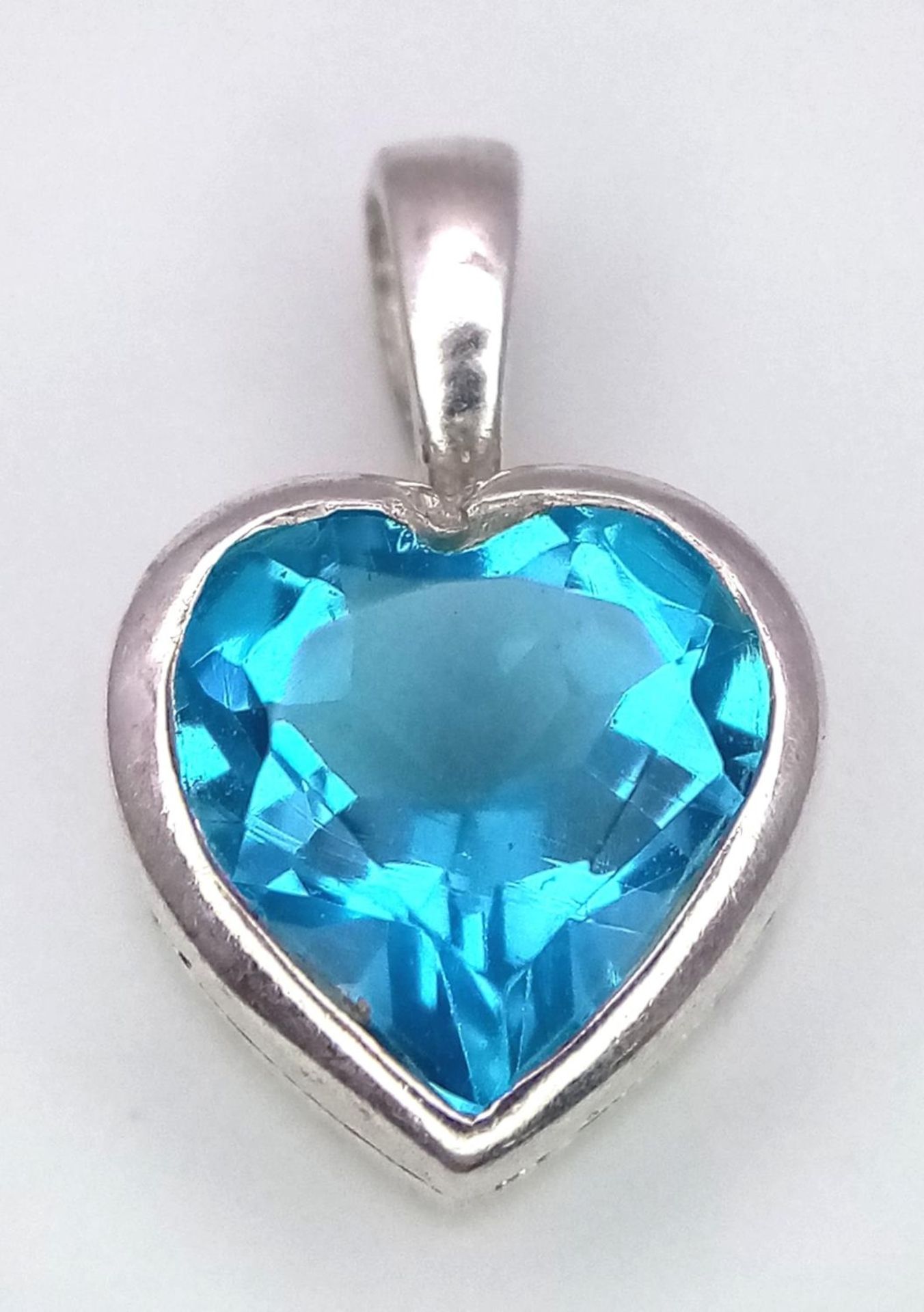 A Blue Topaz Heart Pendant on 925 Silver. 1.7cm length, 1.62g total weight. - Image 2 of 4
