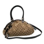 A Gucci Monogram Sukey Satchel Bag. Canvas exterior with leather trim, two rolled leather handles,