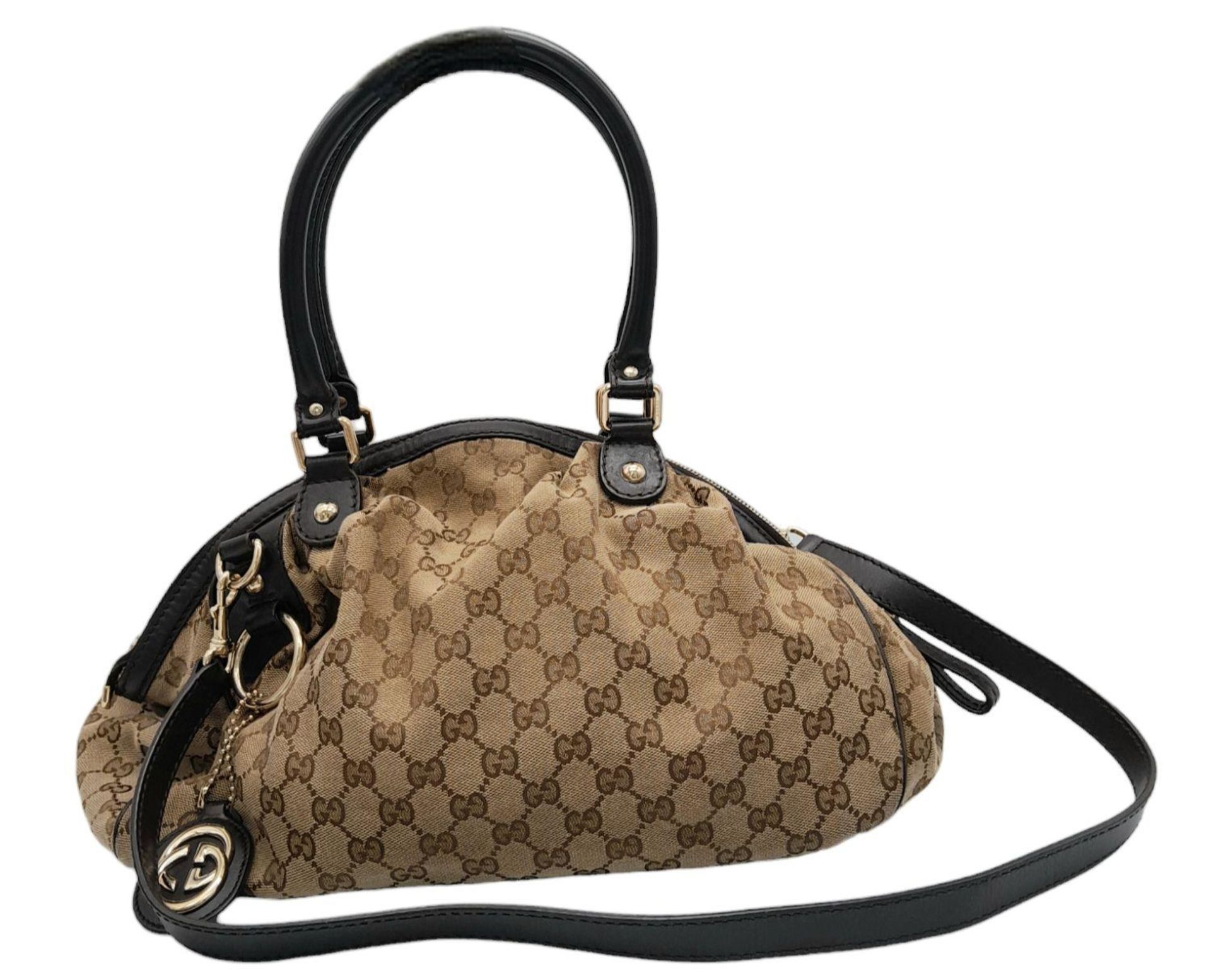 A Gucci Monogram Sukey Satchel Bag. Canvas exterior with leather trim, two rolled leather handles,