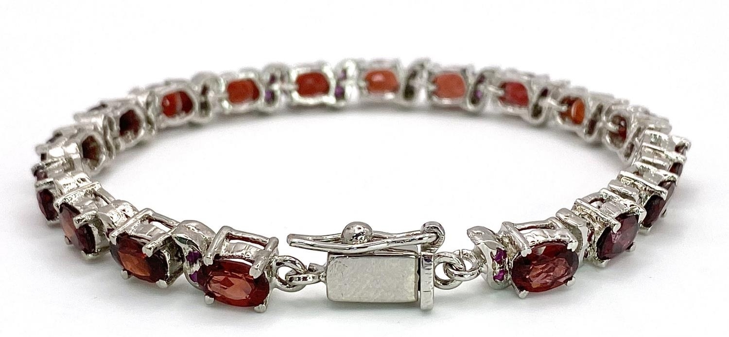 A Garnet Tennis Bracelet set in 925 Sterling silver. 36ctw. W-25.60g. 18cm. - Image 2 of 4