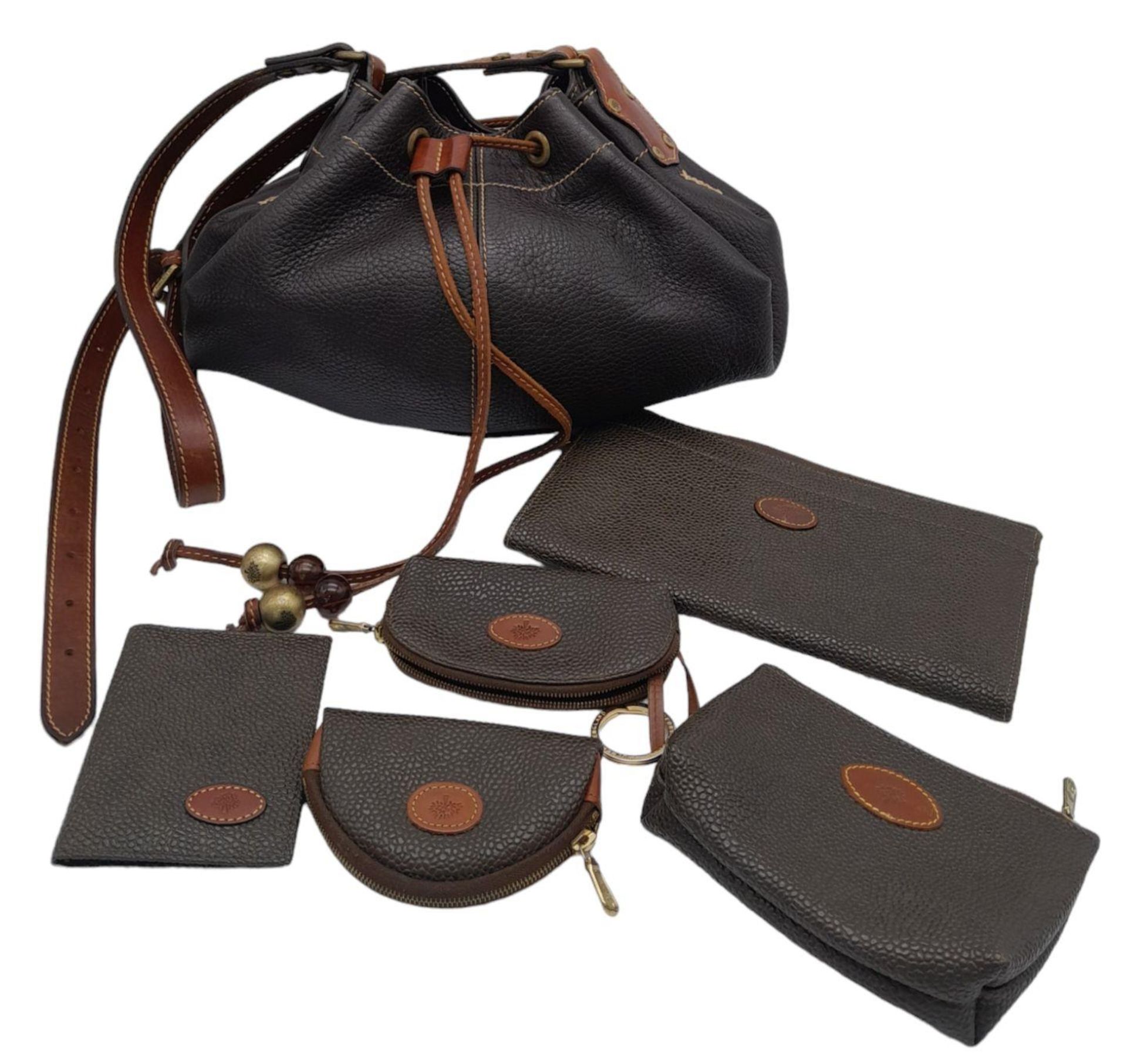 A Mulberry Brown Drawstring Bag. Leather exterior with gold-toned hardware, adjustable strap and