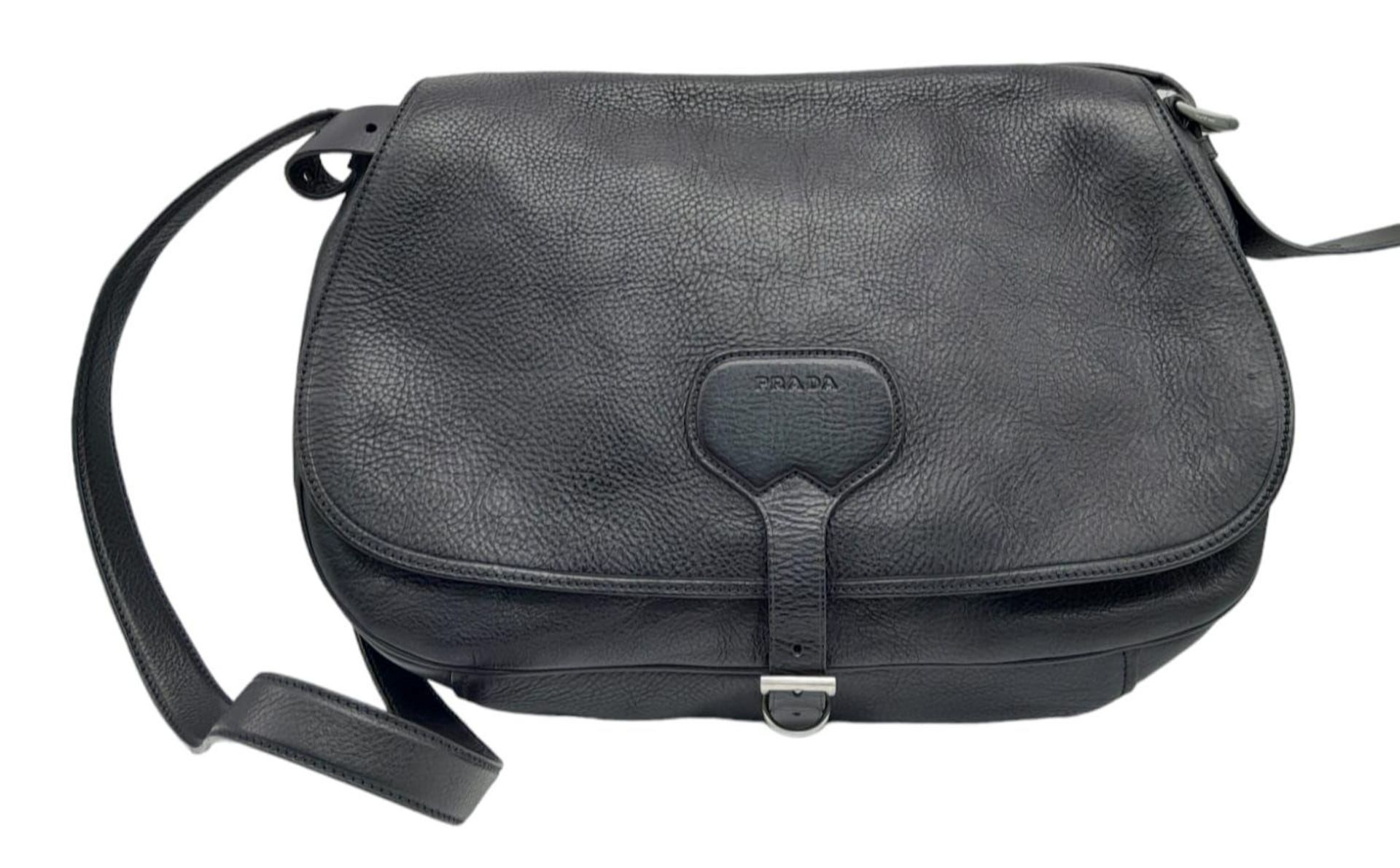 A Prada Black Leather Crossbody Satchel Bag. Textured exterior with buckled flap. Spacious leather