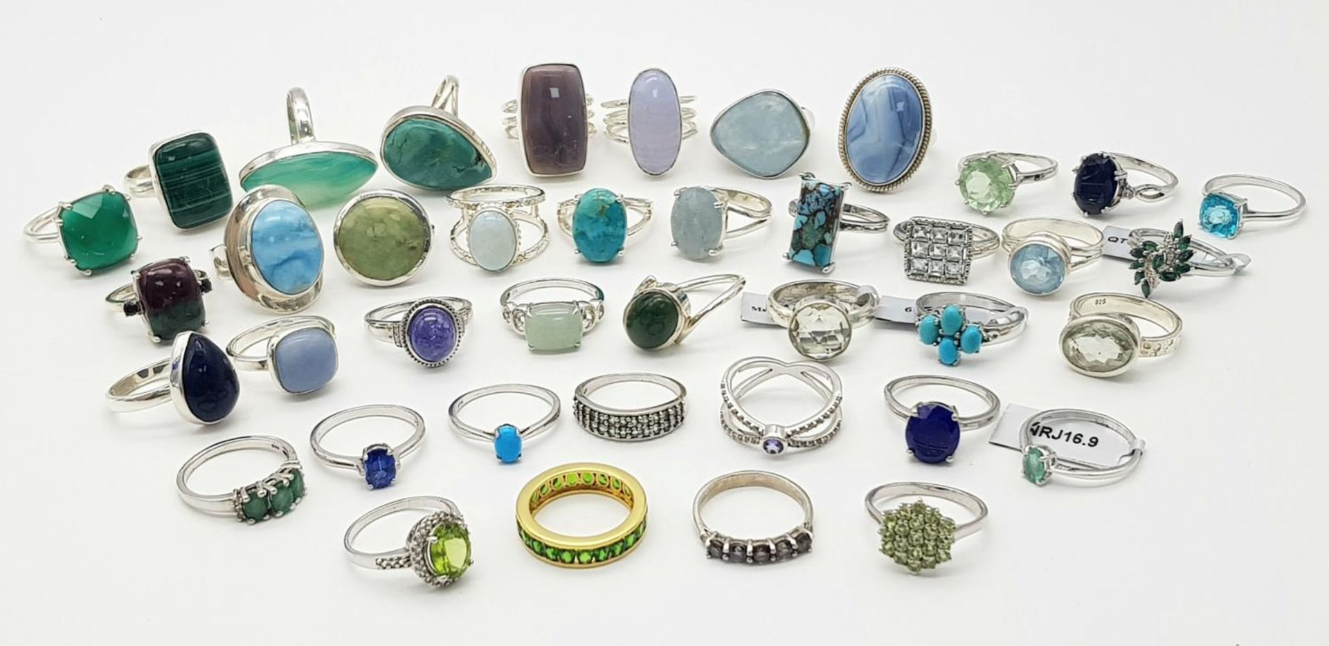 An impressive collection of forty sterling silver rings in a variety of designs. all adorned with