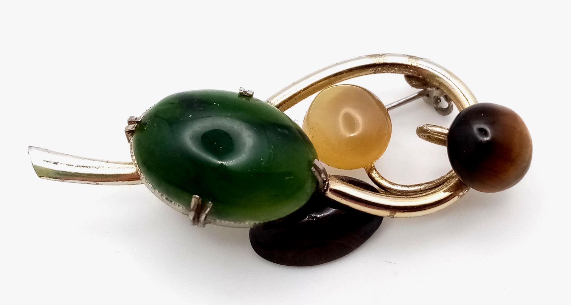 A Magical, Music Note Styled Multi-Gemstone Brooch. Jade, tigers eye, moonstone and agate hit the