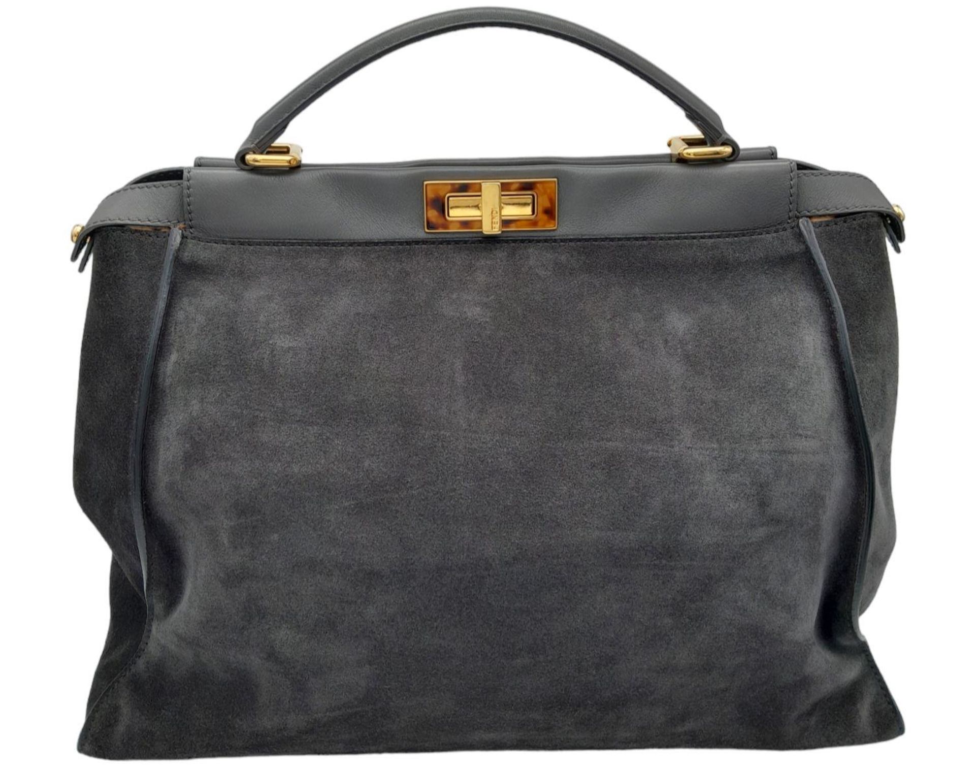 A Fendi Grey Peekaboo Bag. Suede exterior with leather trim, single leather handle, gold-toned
