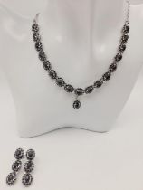 A Blue Sapphire Silver Choker Necklace with Matching Drop Earrings. Both set in 925 sterling silver.