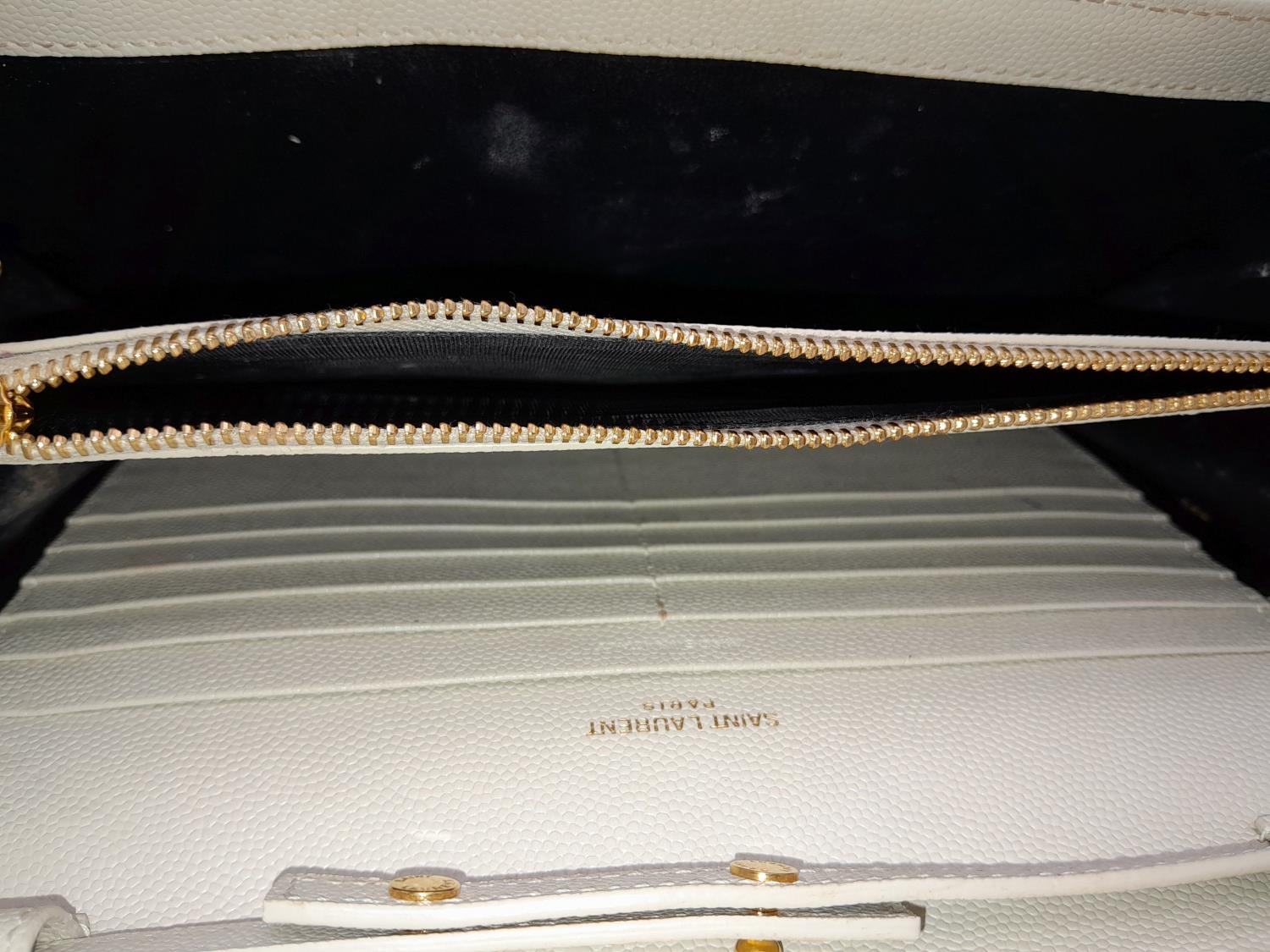 A YSL Ivory Cassandre Wallet Bag. Leather exterior with gold-toned hardware, the iconic YSL logo, - Image 5 of 13