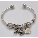 A Pandora 925 Silver Charm Cuff Bangle. Comes with a Pandora presentation case.