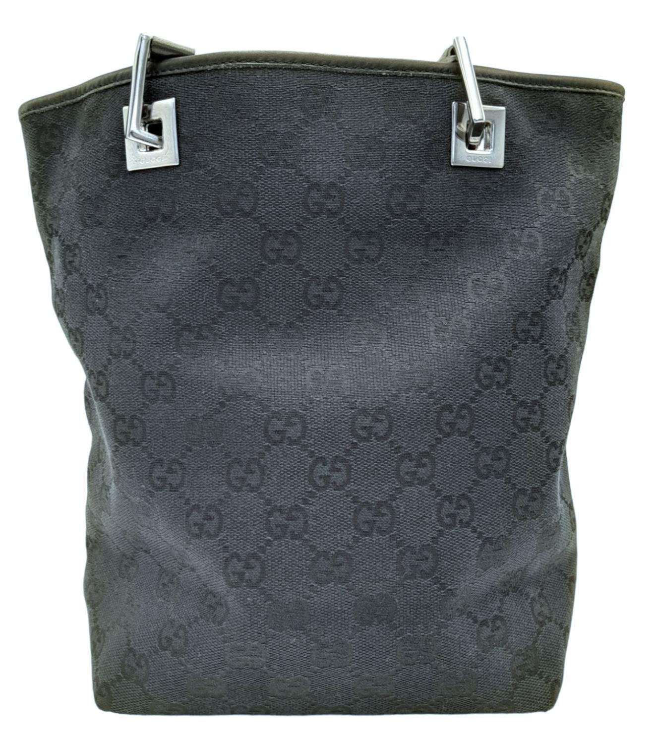 A Gucci Black Monogram Tote Bag. Canvas exterior with leather trim, two leather straps and silver- - Image 4 of 8