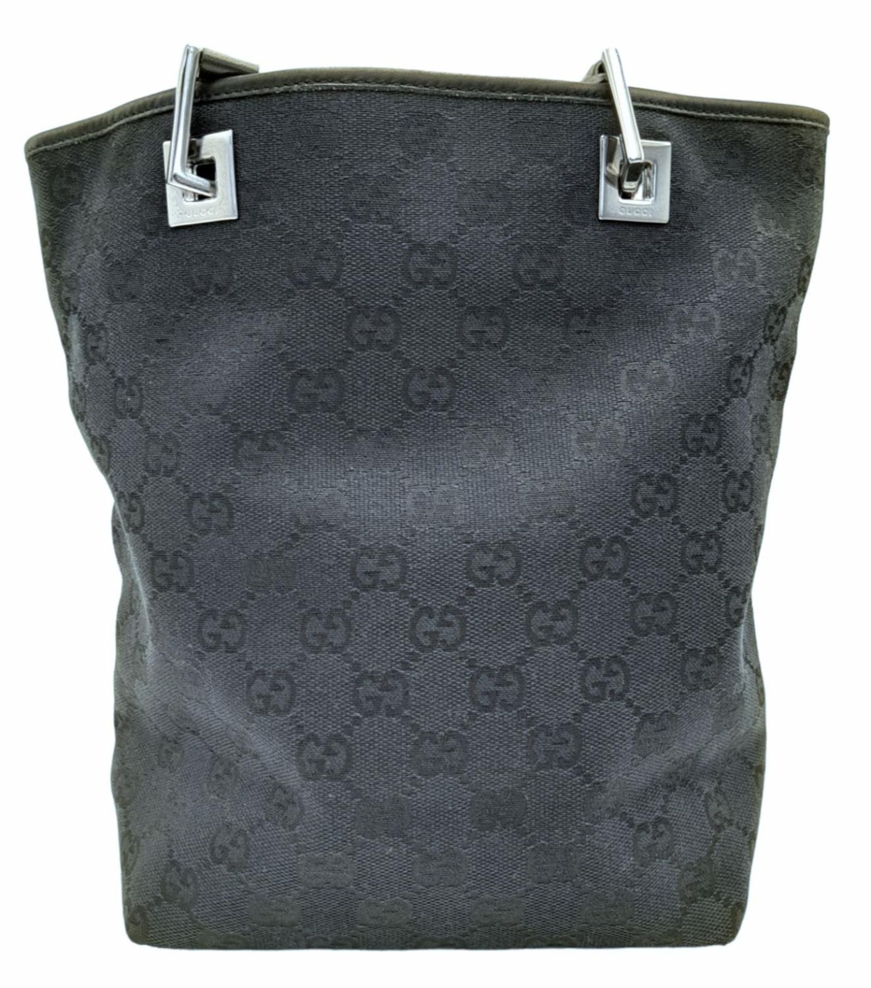 A Gucci Black Monogram Tote Bag. Canvas exterior with leather trim, two leather straps and silver- - Bild 4 aus 8