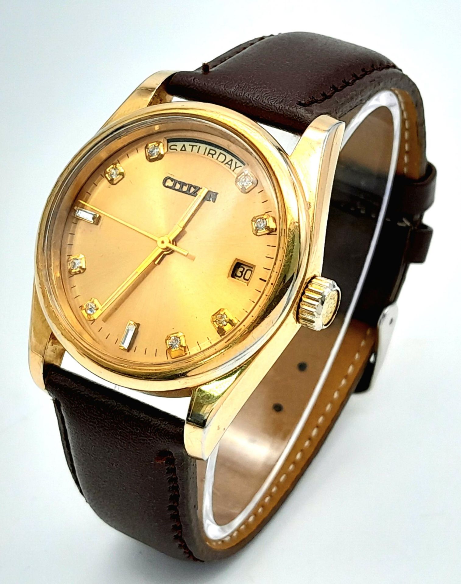 A Citizen Automatic Stone Set Watch. Brown leather strap. Gold plated case - 36mm. Gold tone dial