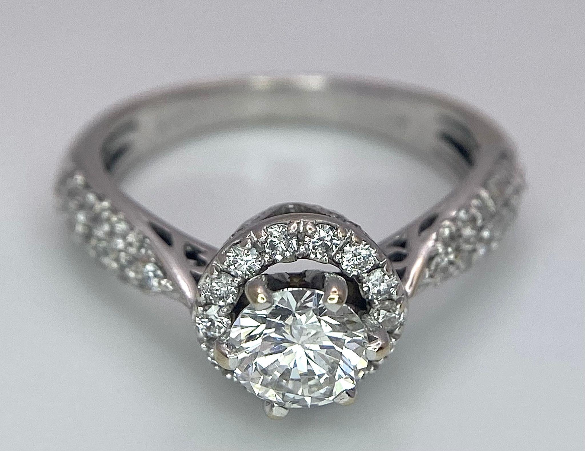 An 18K White Gold Diamond Ring. Central 0.75ct brilliant round cut diamond with a diamond halo and - Image 8 of 10