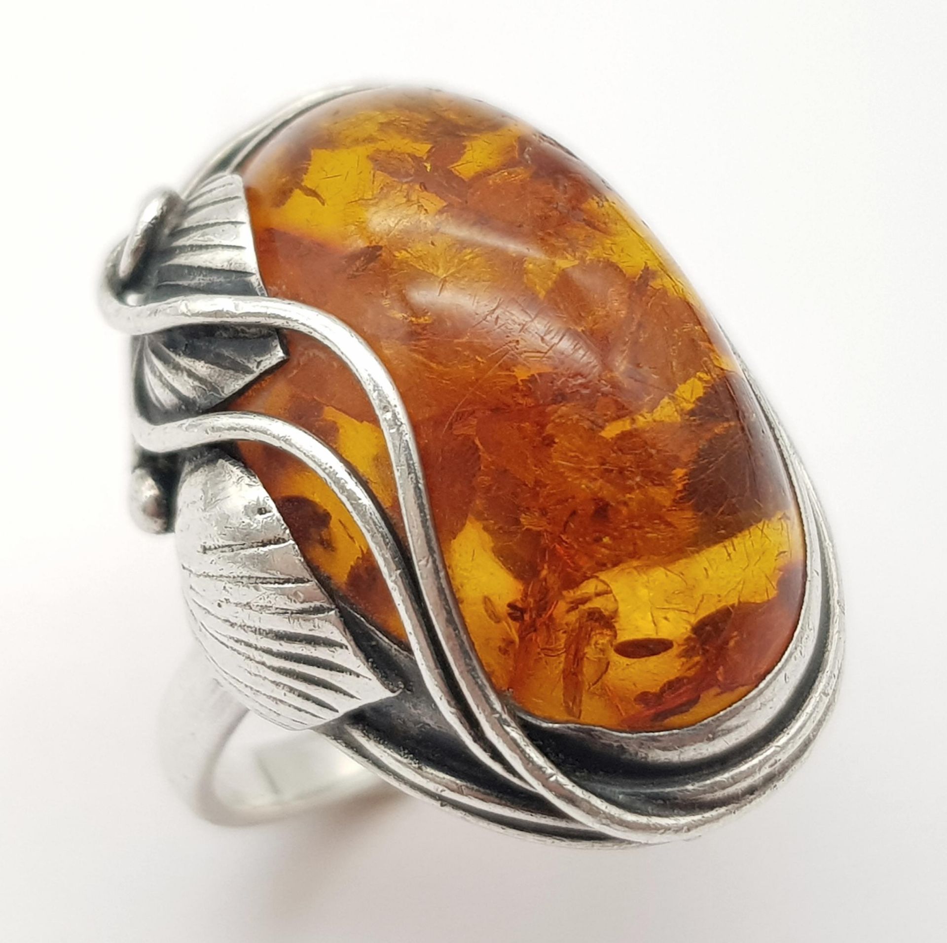 A Vintage Sterling Silver Hallmarked 1991 Ornate Mounted Amber Cabochon Ring Size P. Set with a 2.