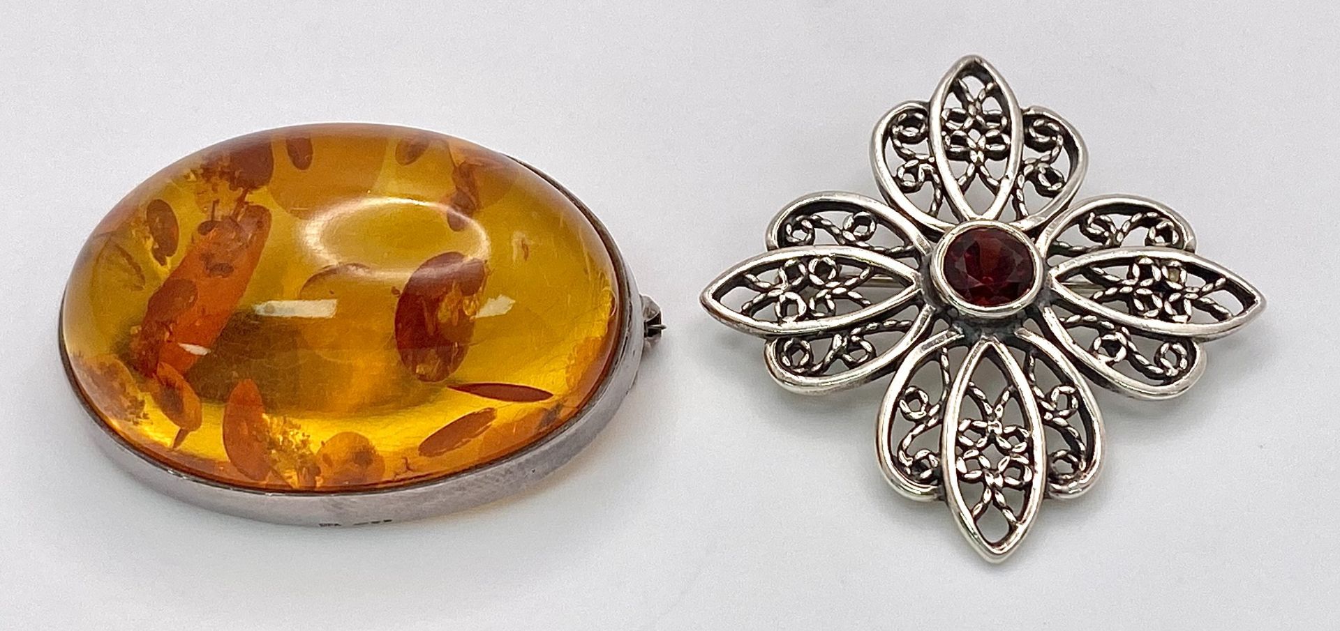 Two Different Style Silver Brooches. Amber and Garnet. Both 3.5cm. Ref: 66001R.