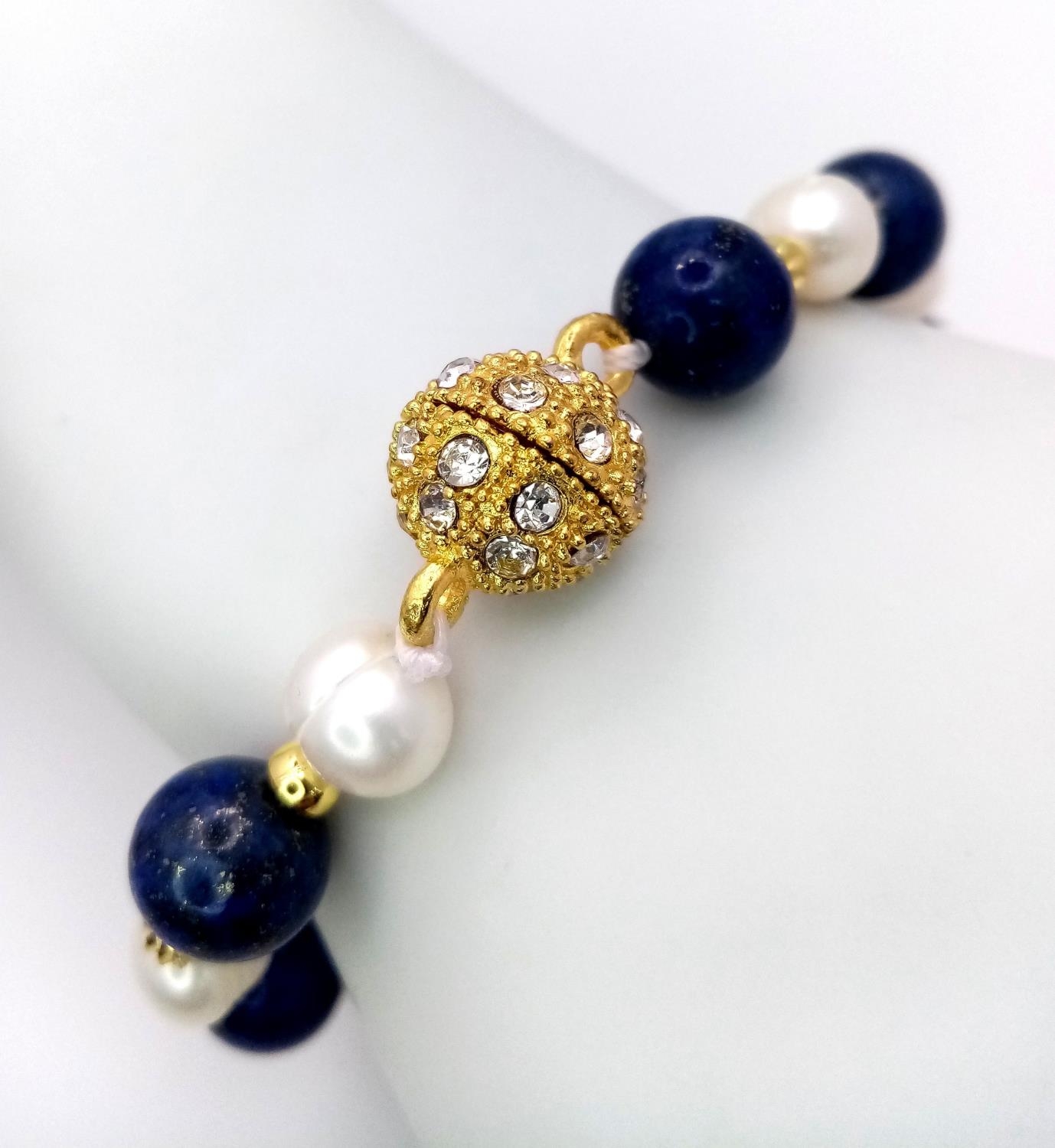 A Lapis Lazuli and Cultured Pearl Bracelet with Glitterball Clasp. 18cm