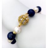 A Lapis Lazuli and Cultured Pearl Bracelet with Glitterball Clasp. 18cm