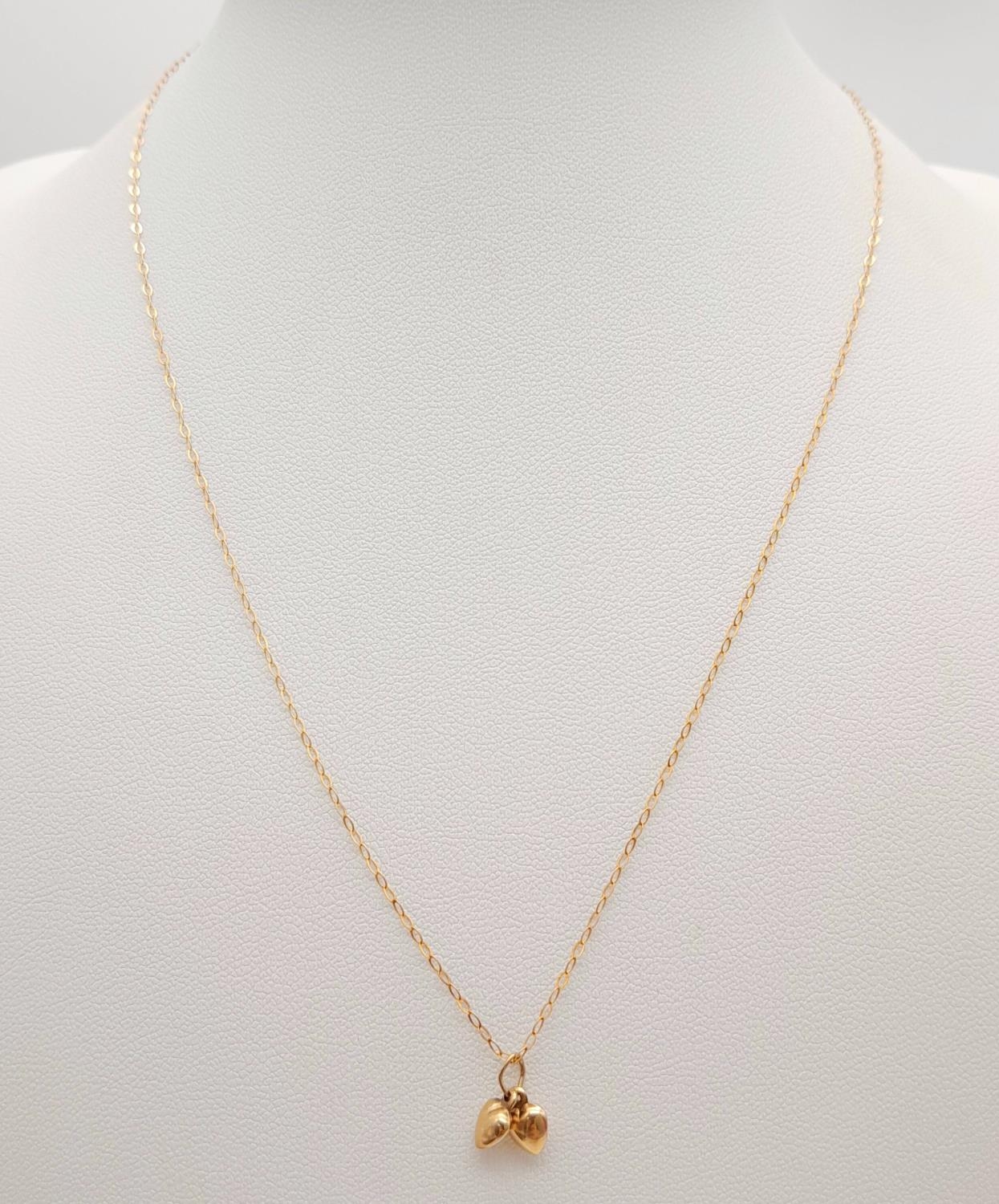 A 9ct Yellow Gold Double Heart Necklace, 16” length, 0.6g total weight , 0.7cm pendant drop. ref: