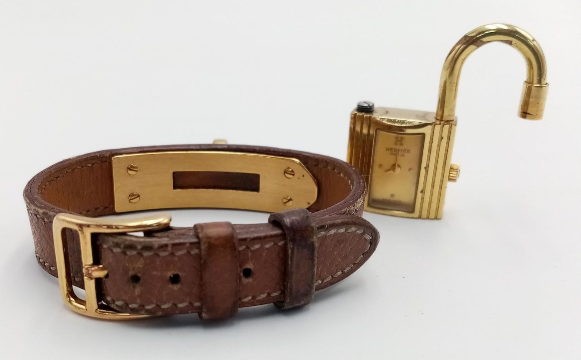 A Hermes Kelly Watch. Brown leather strap. Gold plated padlock quartz watch. Needs a battery so as - Image 5 of 7