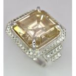A 16.20ct Champagne Moissanite Dress Ring set in 925 Silver. Comes with a presentation case. Size N.