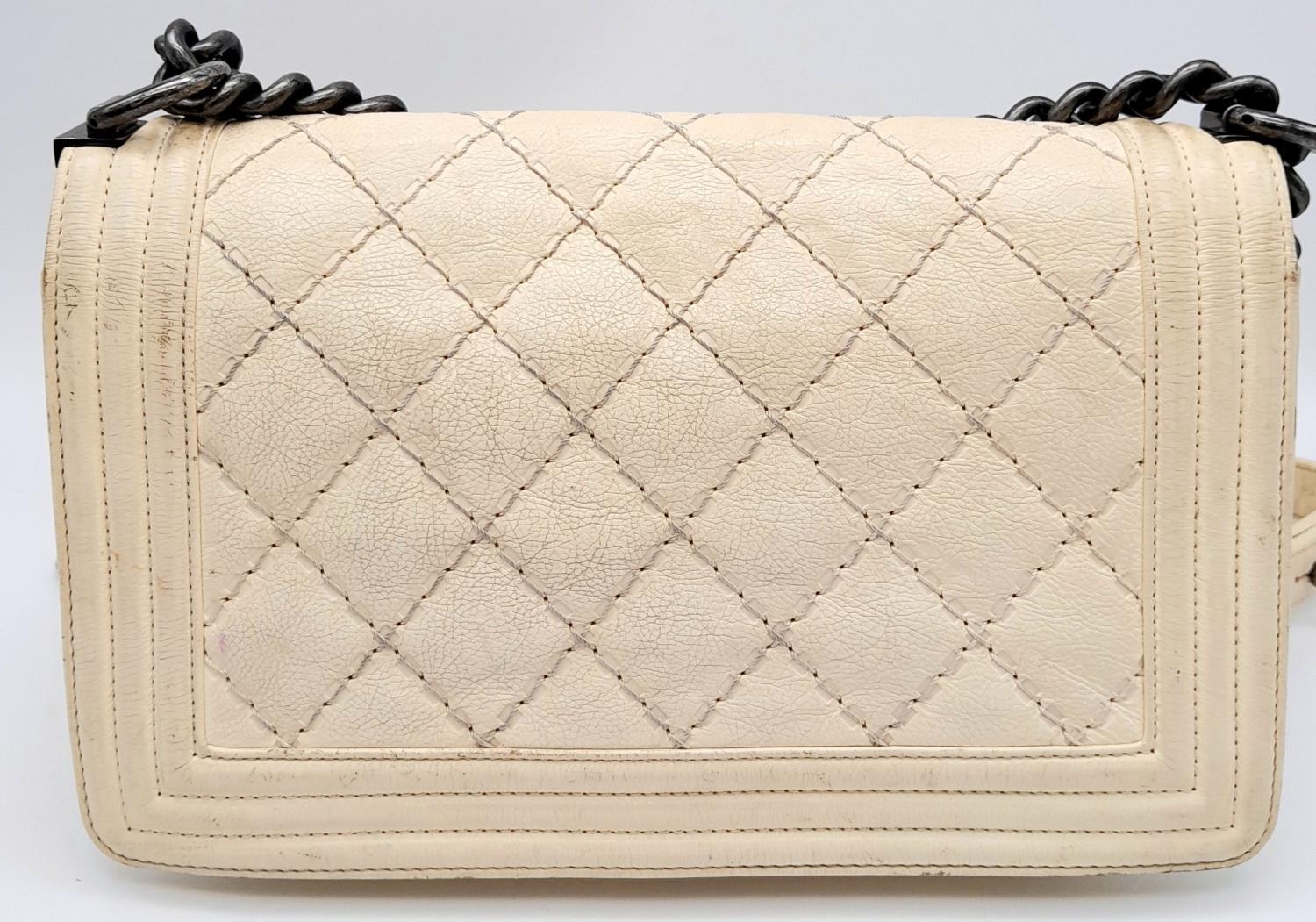 A Chanel Ivory Boy Bag. Leather exterior with chrome-toned hardware, chain and leather strap, and - Image 2 of 15