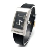 A DKNY Quartz Ladies Watch. Black leather strap. Stainless steel case - 24mm. Analogue/digital dial.