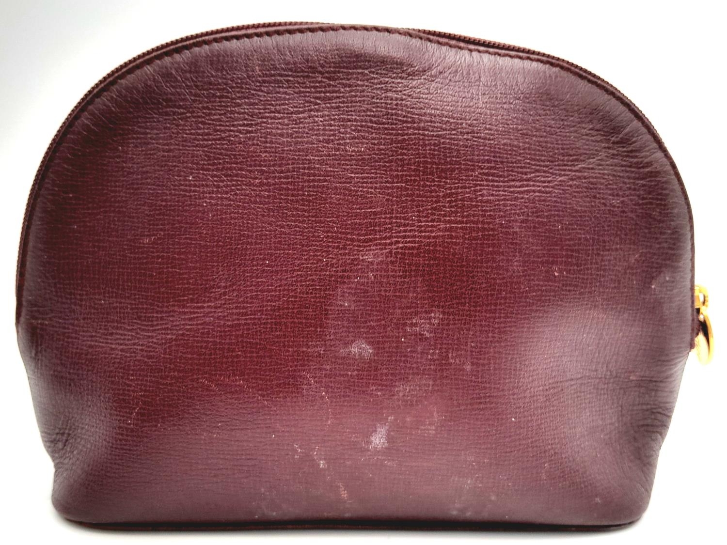 A Vintage Cartier Burgundy Pouch. Leather exterior with zip top closure. Burgundy canvas interior. - Image 3 of 11
