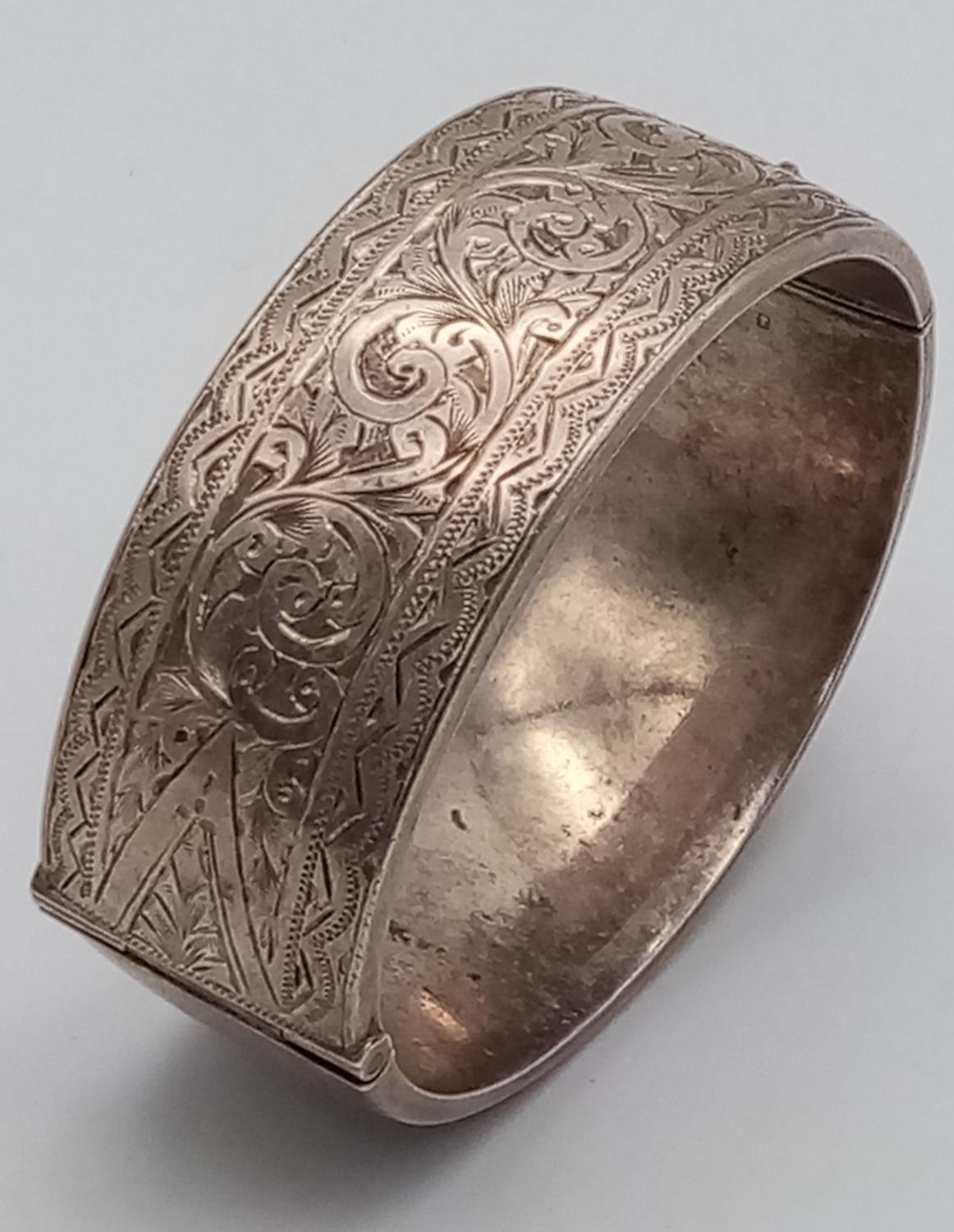 A Silver Victorian Engraved Bangle. 6.3cm diameter, 3cm band width, 43.69g weight. - Image 2 of 8