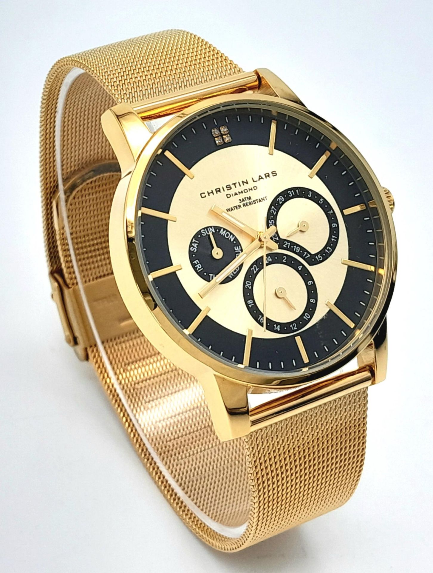 An Unworn Christian Lars Gold Tone Diamond Set Watch. 41mm Case. Replacement Battery Fitted April