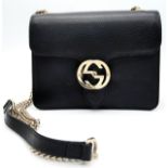 A Gucci Black GG Crossbody Bag. Leather exterior with gold-toned hardware, chain and leather