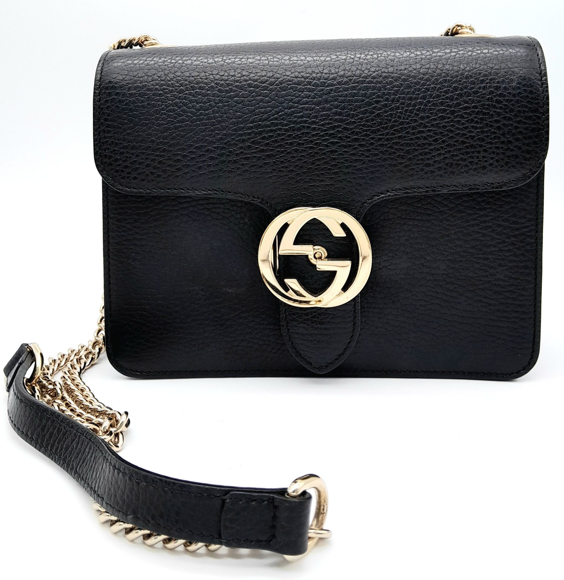 A Gucci Black GG Crossbody Bag. Leather exterior with gold-toned hardware, chain and leather