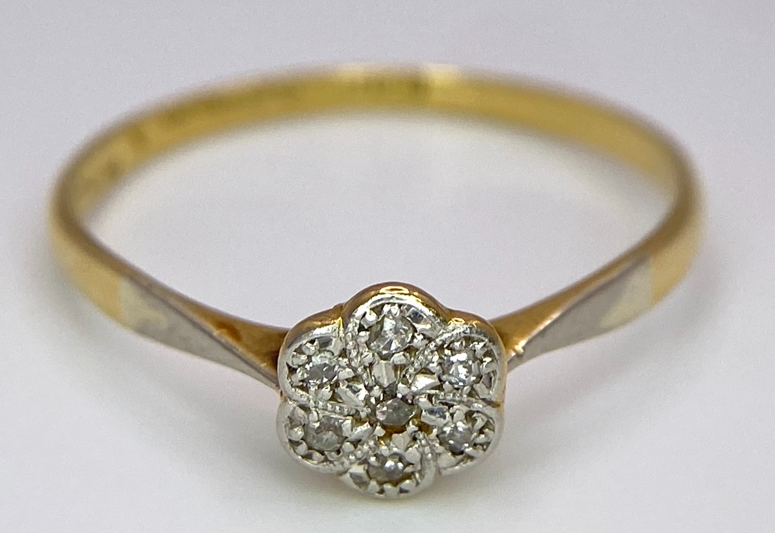 An 18K Yellow Gold, Platinum Diamond Ring. Size Q. Seven old cut diamonds in a decorative floral - Image 4 of 6