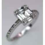 An 18K White Gold, Rectangular, Baguette and Round Cut Diamond Ring. Size L 1/2. 2.8g total weight.
