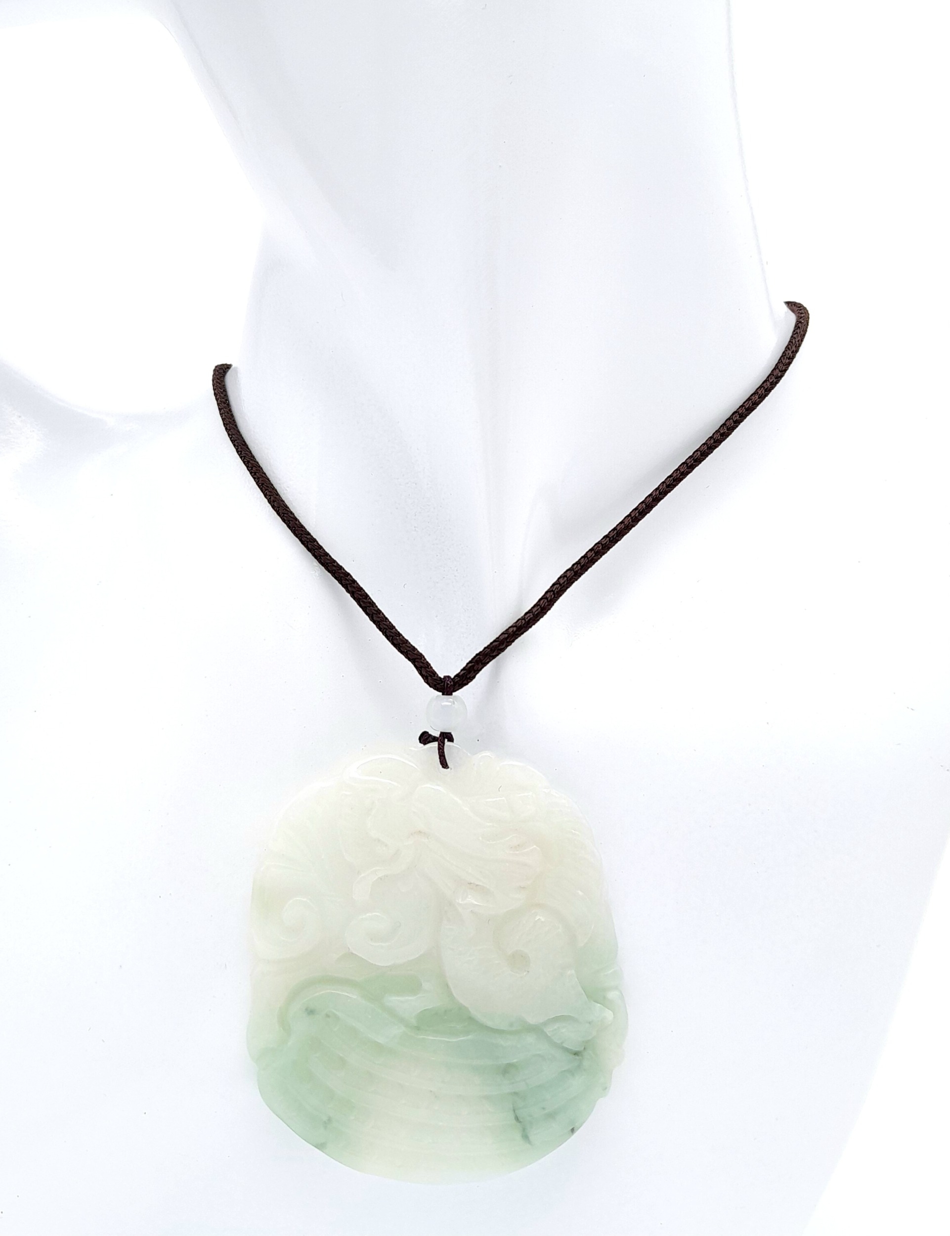 A Dragon Jade Pendant on an Adjustable Necklace. 5.5cm length. 25g total weight.