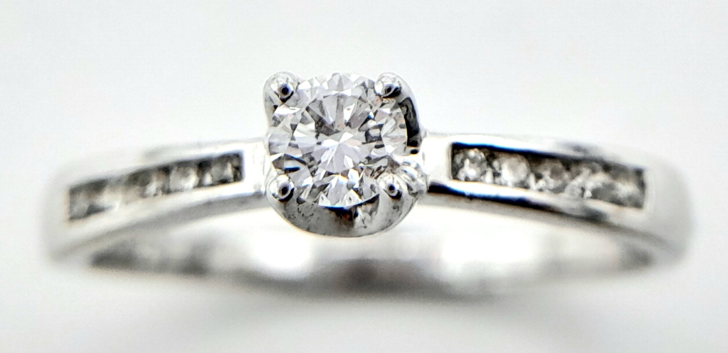 AN 18K WHITE GOLD DIAMOND SOLITAIRE RING - WITH DIAMOND SHOULDERS. 0.25CT. 1.9G. SIZE L - Image 2 of 6