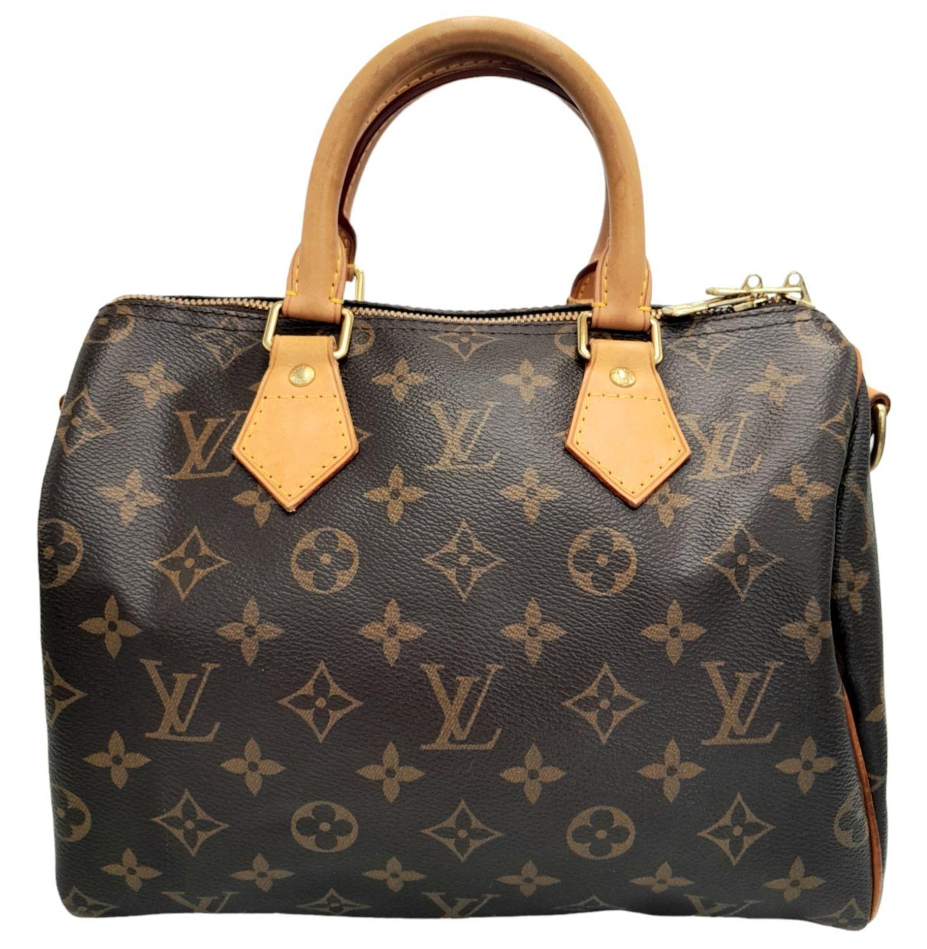 A Louis Vuitton Speedy Bag. Monogramed canvas exterior with gold-toned hardware, two rolled