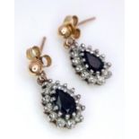 A 9 K yellow & white pair of earrings with a tear drop sapphire surrounded by diamonds. Weight: 1.