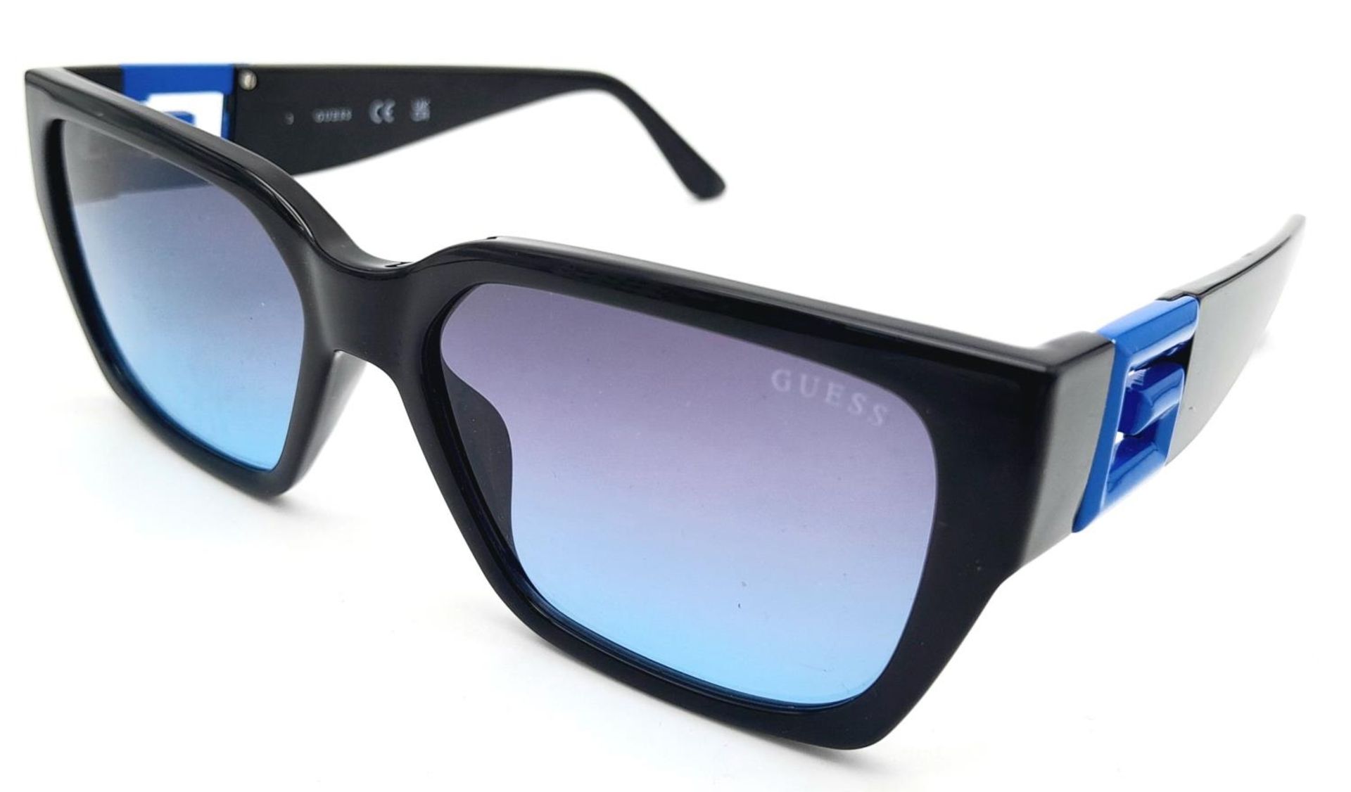 A Pair of Designer Guess Sunglasses.