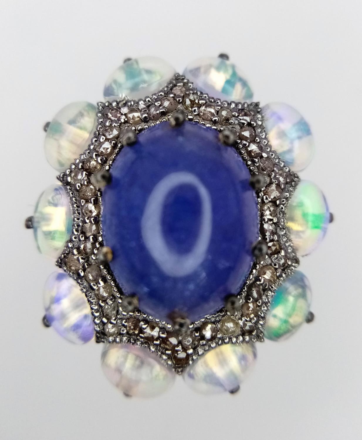 A 10ct Tanzanite Gemstone Dress Ring with 3ctw Opal Surround and 0.50ctw of Diamond Accents. Size N. - Image 2 of 5