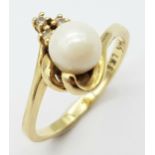 A Vintage 14K Yellow Gold Pearl and Diamond Crossover Ring. Size M. 2.65g total weight.