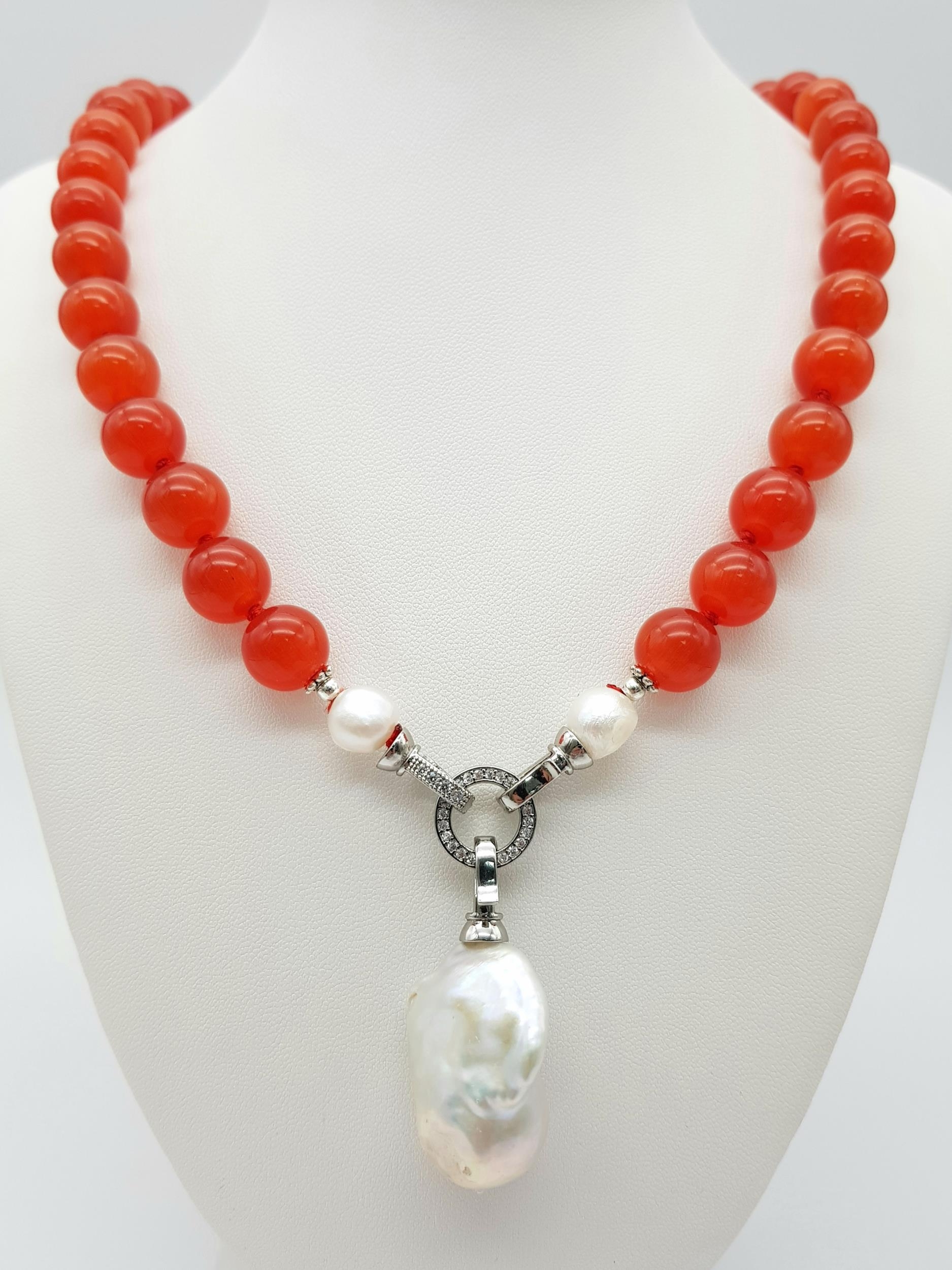 A Deep Orange Cat's Eye Beaded Necklace with a Hanging Keisha Baroque Pearl Pendant. 12mm beads.