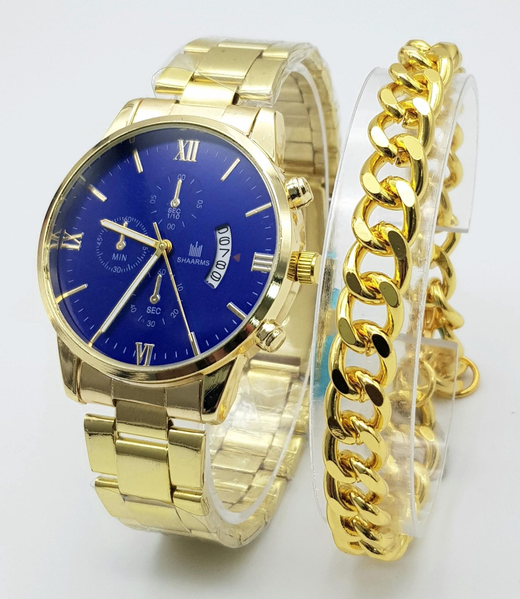 A gold plated Shaarms gents watch accompanied by a gent’s gold plated chain bracelet. Watch has a 42