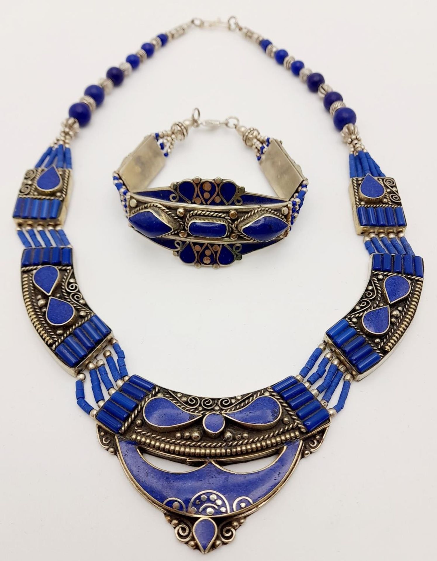 A tribal, wonderfully crafted, white metal and lapis lazuli necklace and bracelet set in a