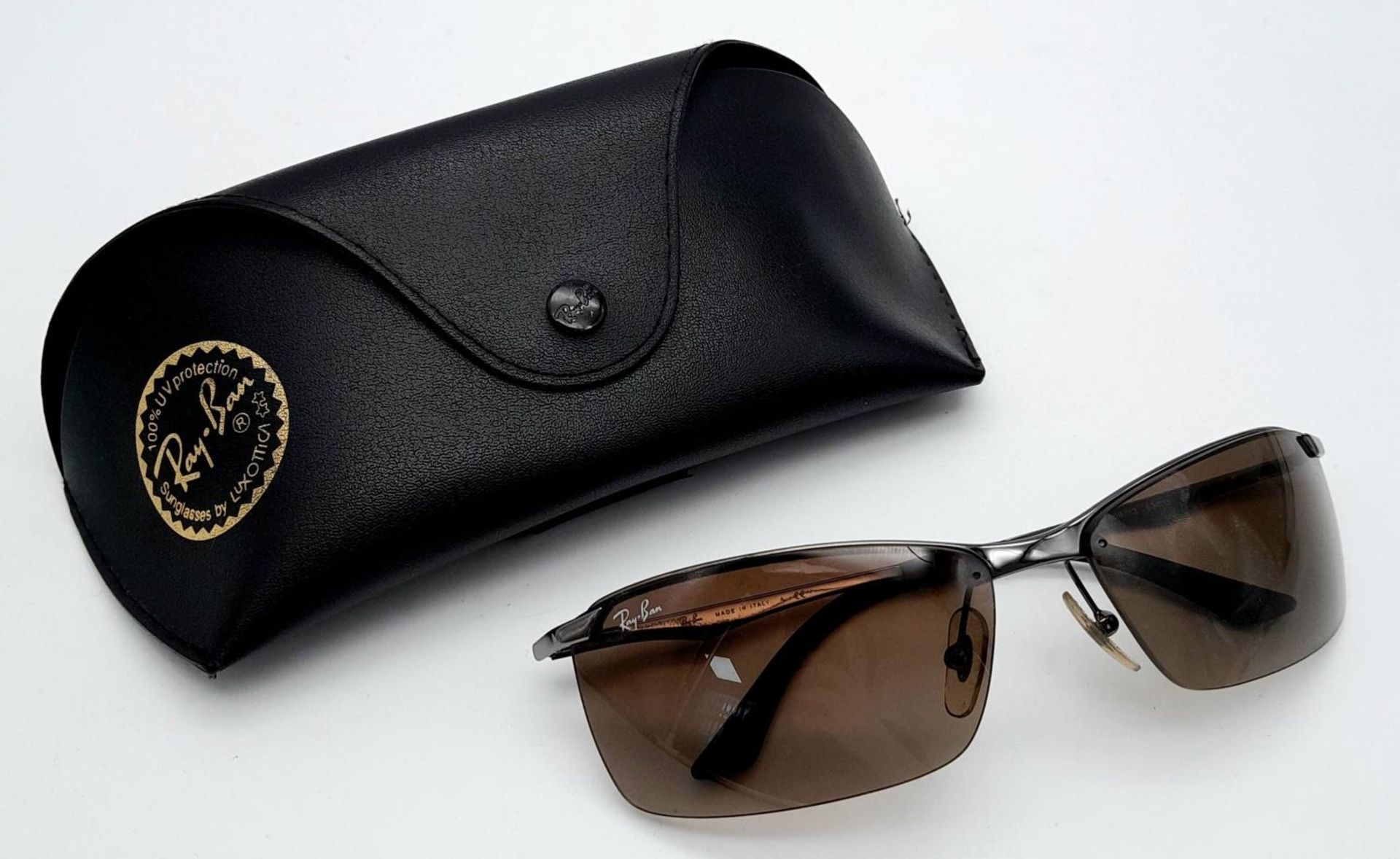 A Pair of Ray Ban Sunglasses - With case that needs restitching.