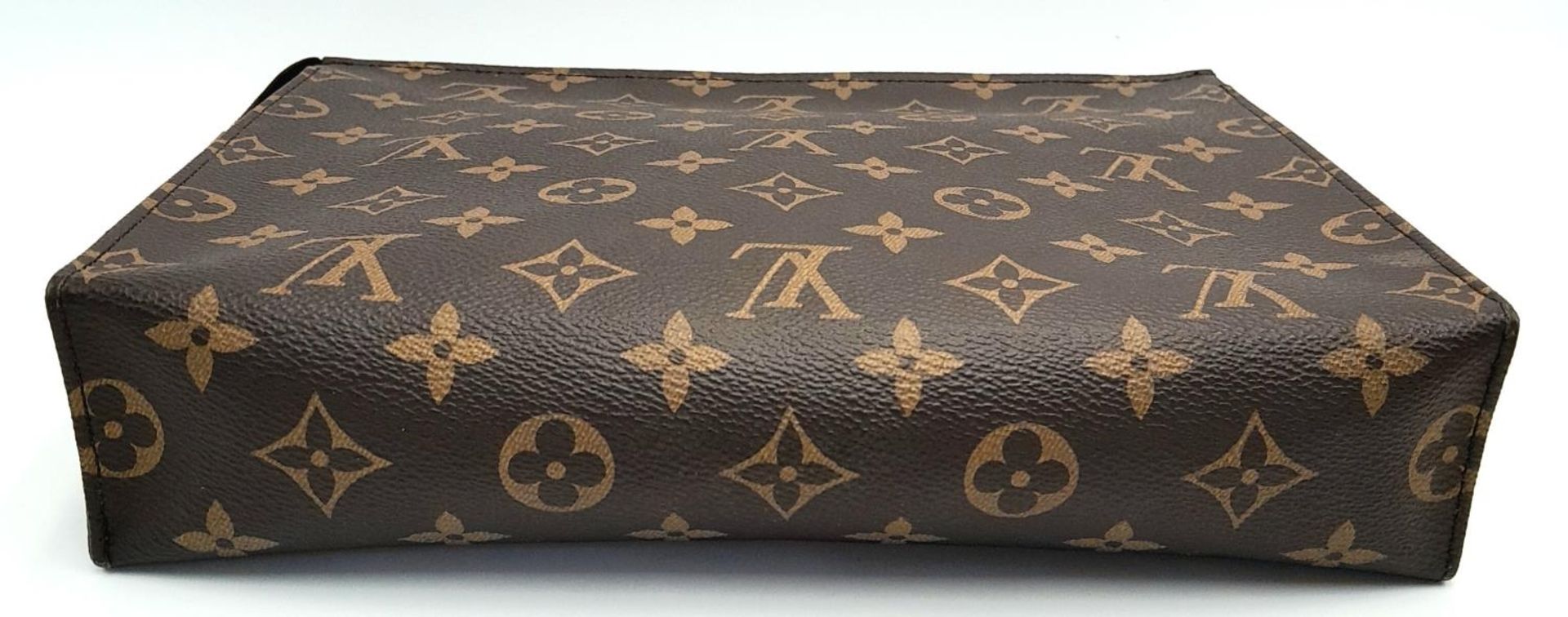 A Louis Vuitton Toiletries Pouch. Monogramed canvas exterior with gold-toned hardware and zipped top - Image 5 of 9