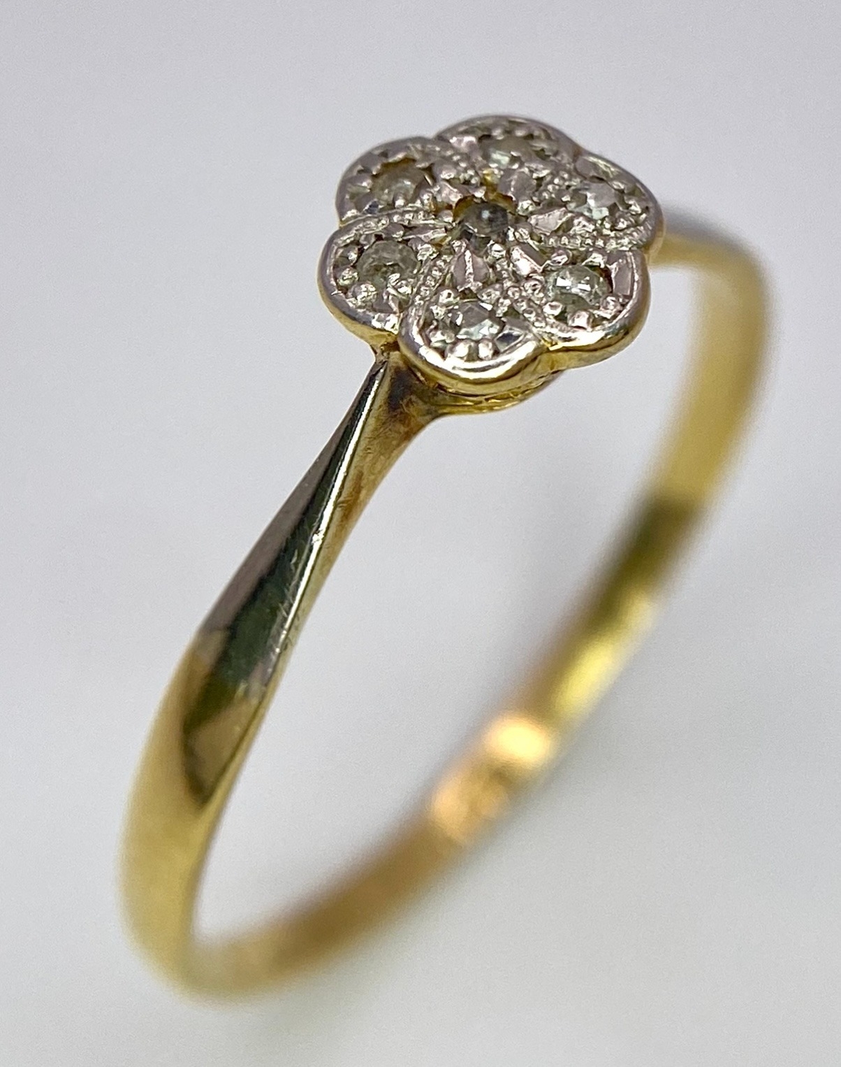 An 18K Yellow Gold, Platinum Diamond Ring. Size Q. Seven old cut diamonds in a decorative floral - Image 2 of 6